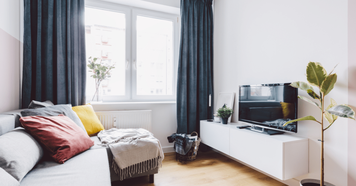 Apartment living room with blue curtains.