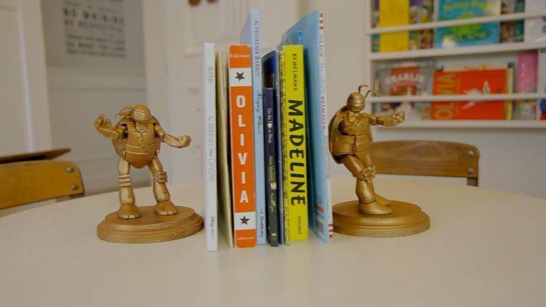 Painted ninja turtle toys to be bookends.