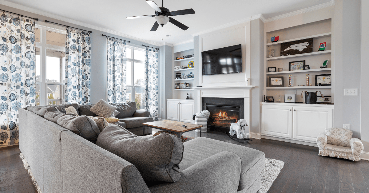 Living room with fireplace and bookshelves.