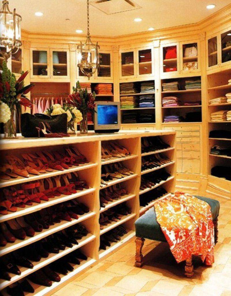 A peak inside Oprah's closet shows shoes, bags, and clothes neatly stored.