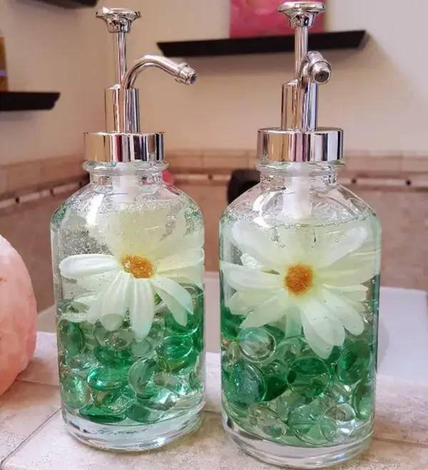 Soap dispenser full of flowers.