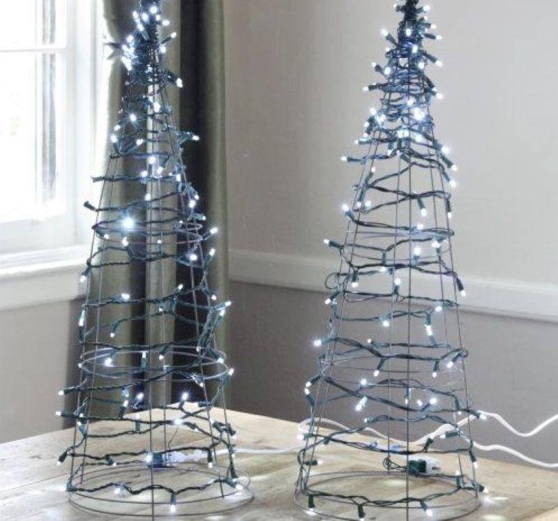 Two blue tree-shaped wired Christmas lights.