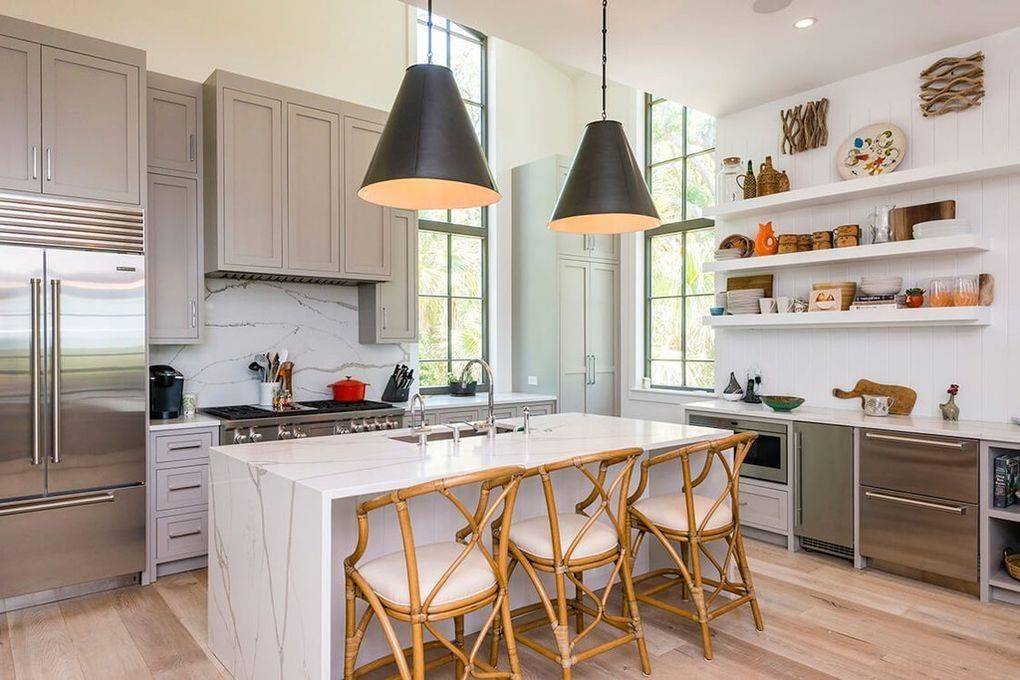 Modern kitchen with wooden chairs.