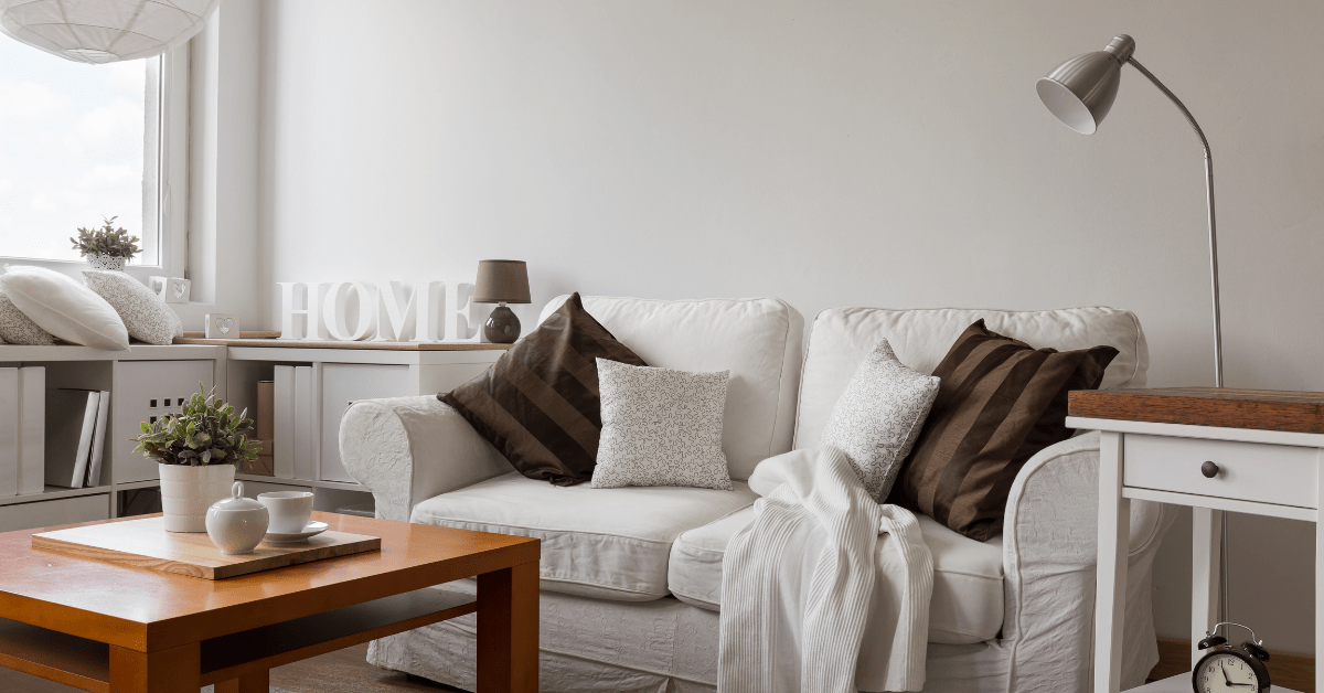 White couch with busy decor.