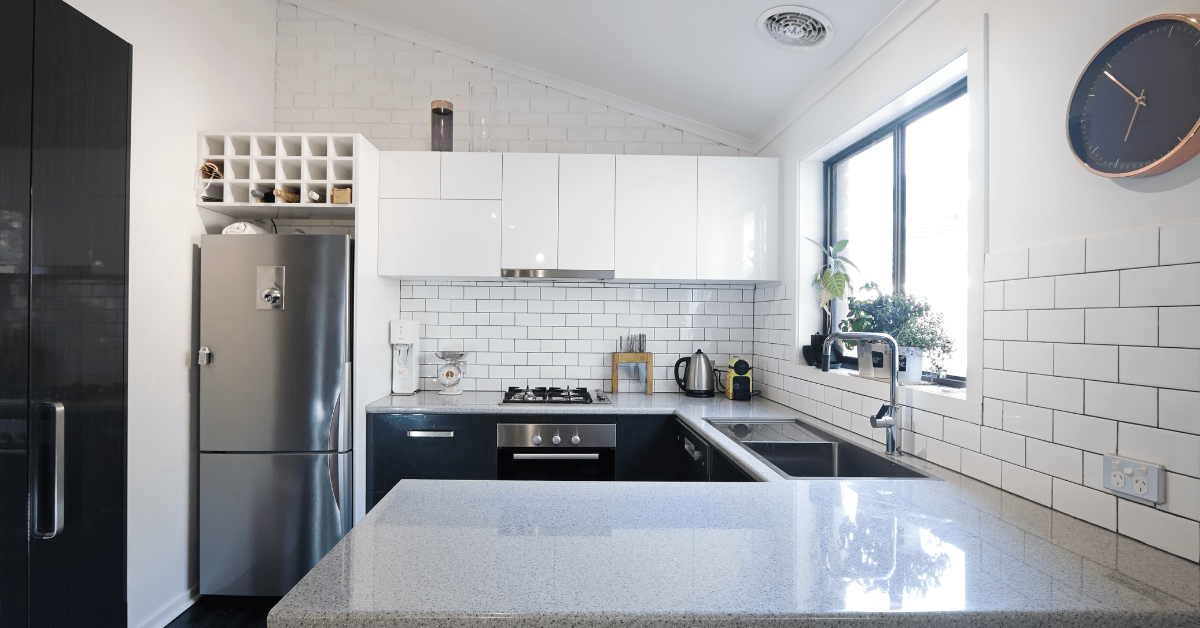 Kitchen with white subway tile and grey grout.