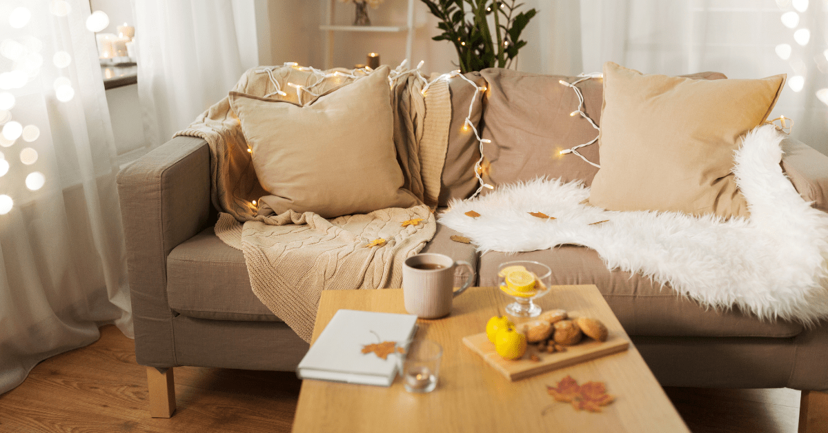 Cozy couch with string lights layered over.