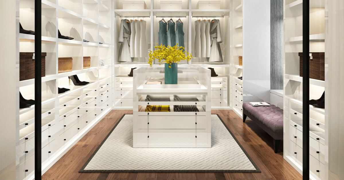 White closet with an island in the middle.