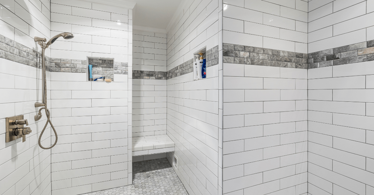 Shower with tile and grey grout.