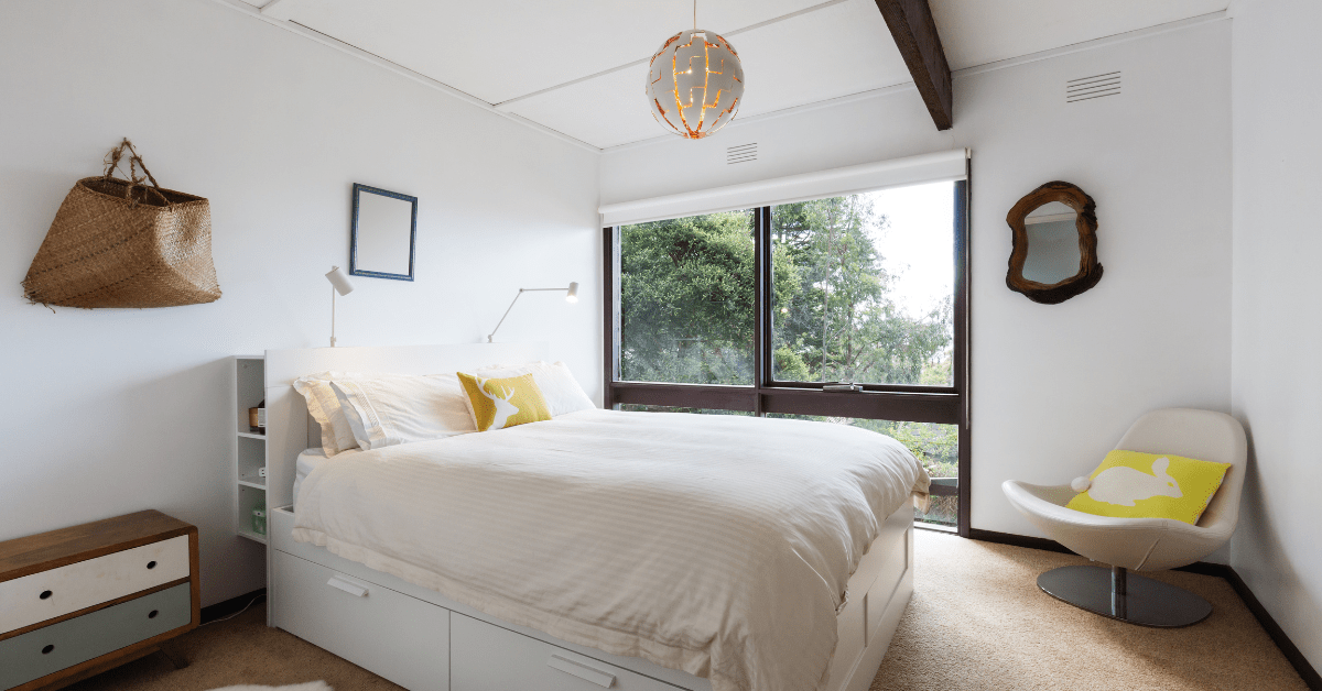 Unique lighting fixture on top of a large bed.