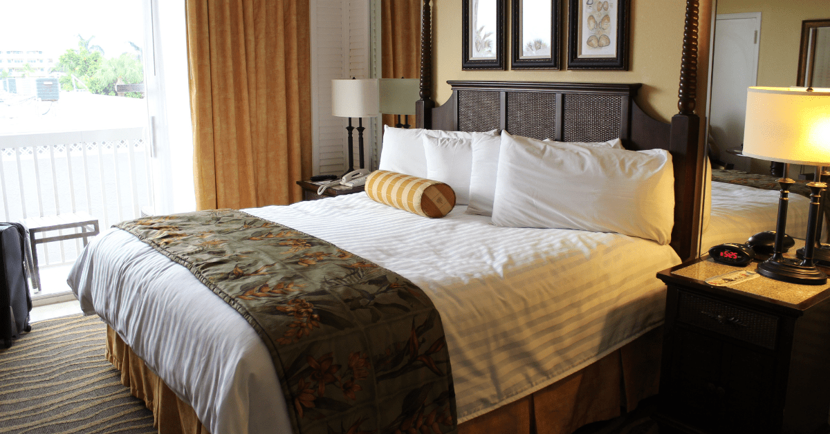 Large bed against a window in a traditional bedroom.