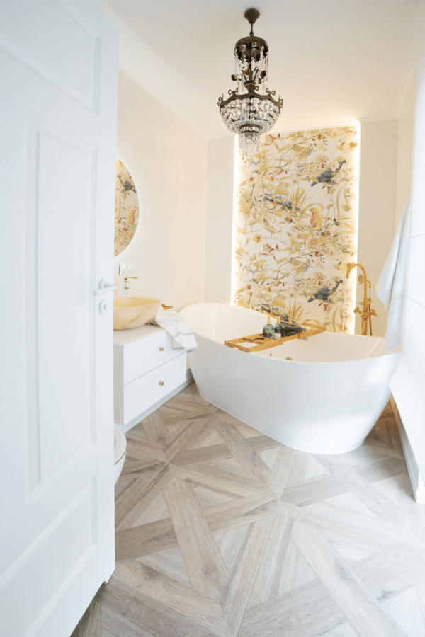 A bright bathroom with a tub.