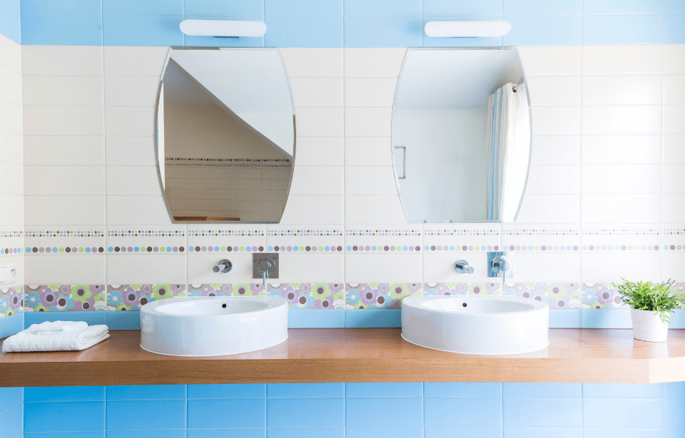 A bathroom vanity with funky tiles.