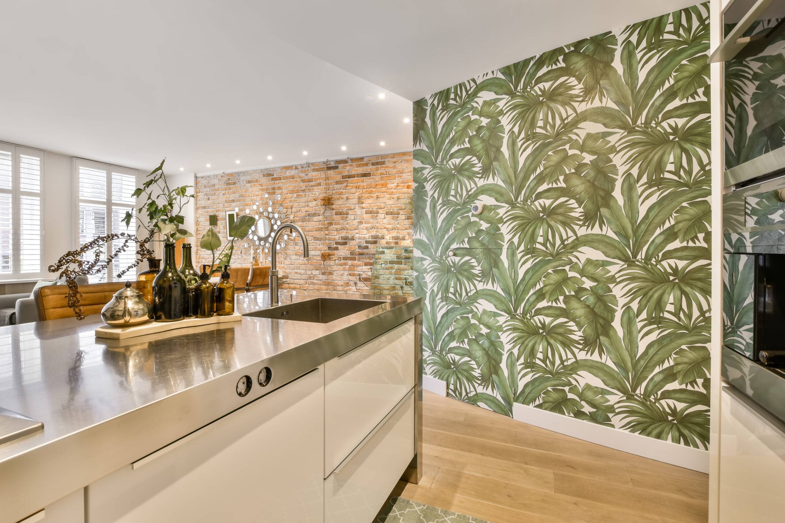 An open-style kitchen with a wallpaper accent wall.