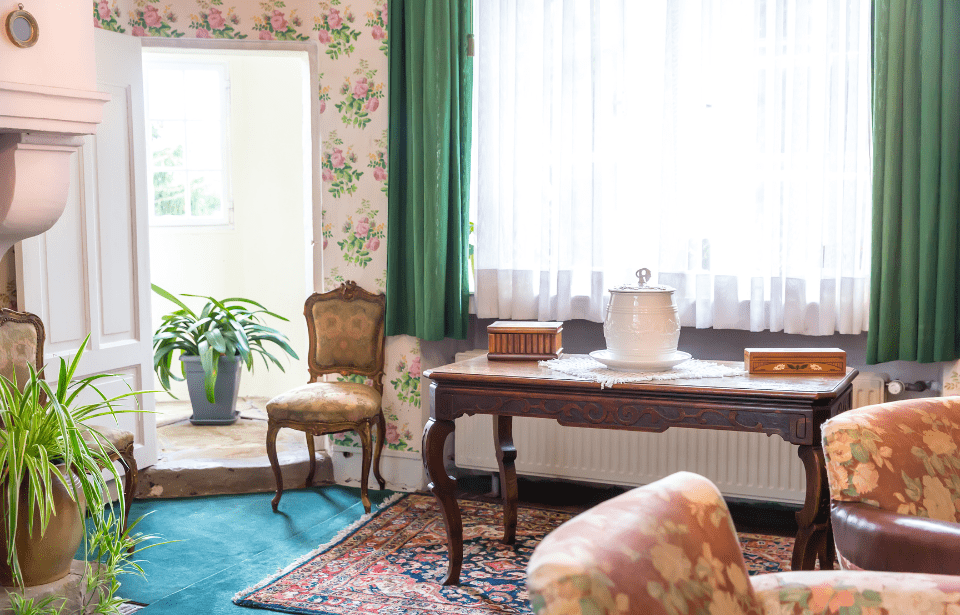 An are in a living room with a console table and chair, eccentrically decorated.