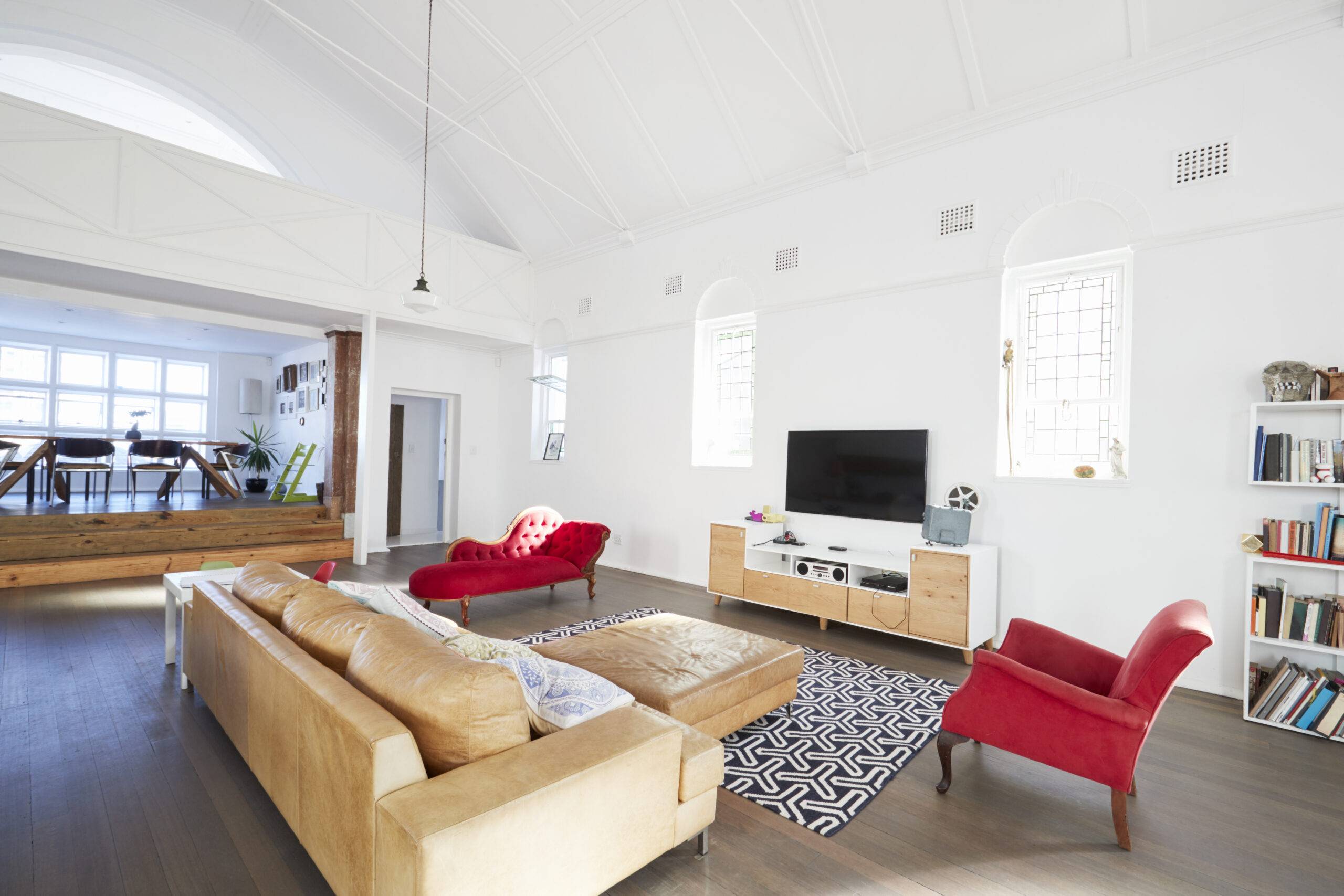 A living room with two red accent chairs.