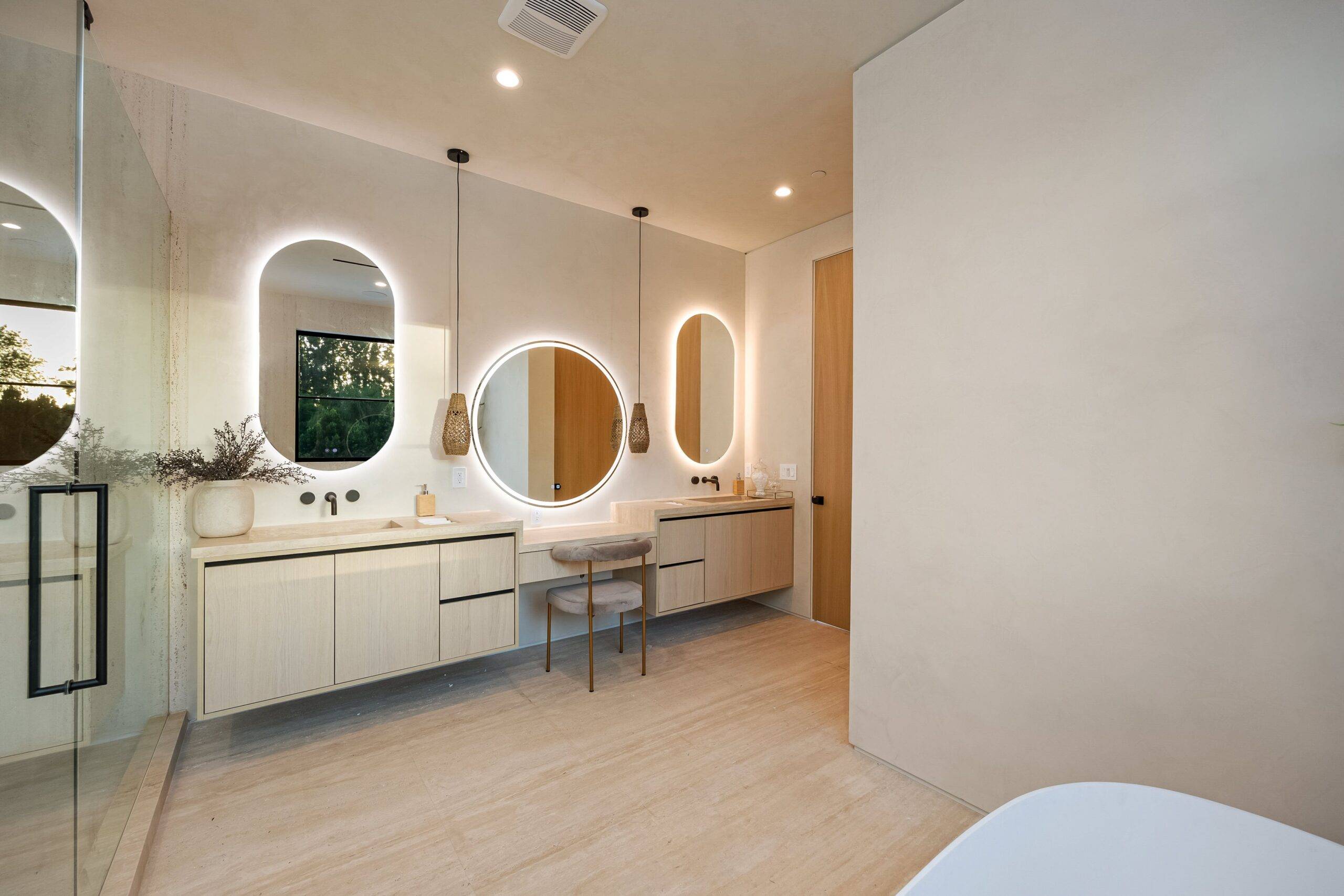 Bathroom vanity with three mirrors with backlighting.