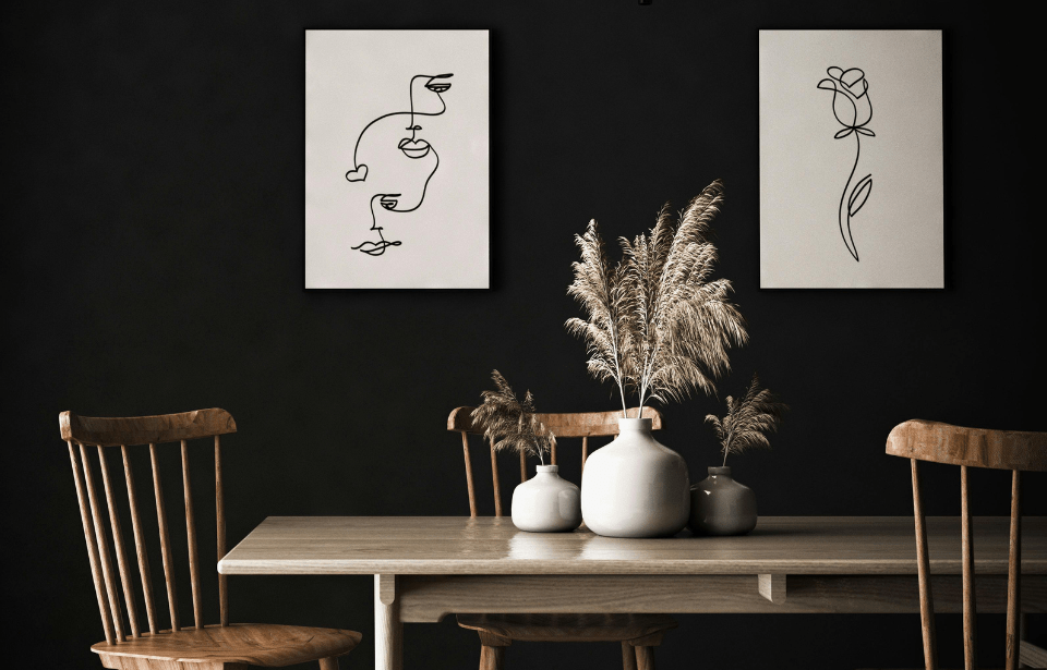 Pampas grass in vases on a dining room table.