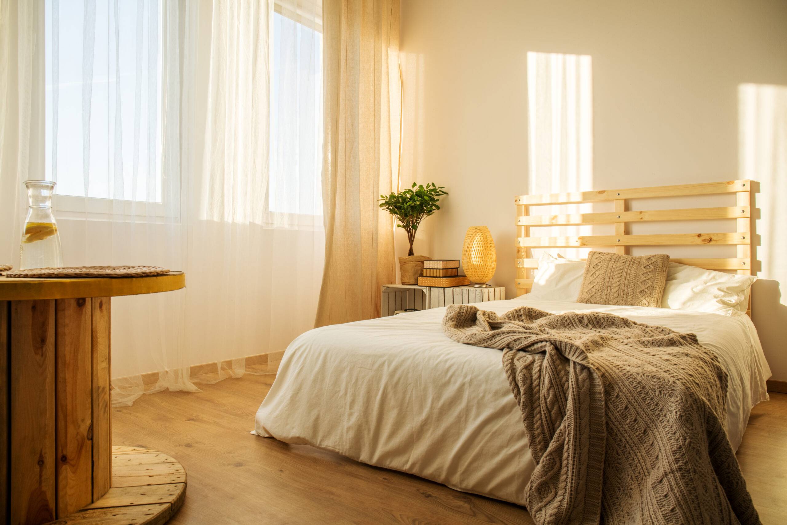 Modern white and beige bedroom with double bed