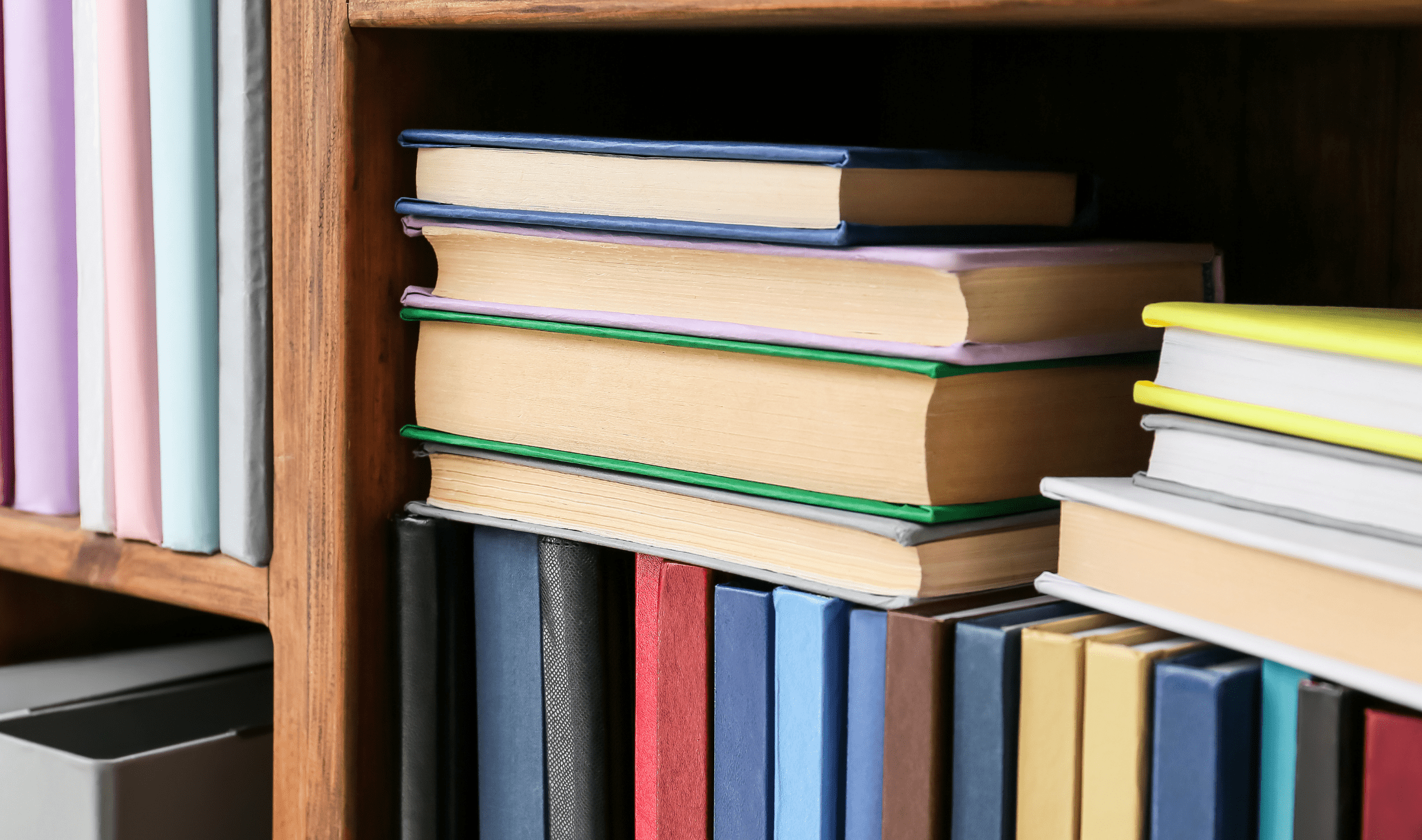 A close photo of a bookshelf with some improperly facing books.