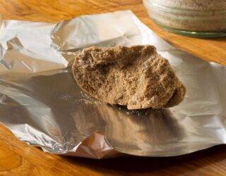 A hardened clump of brown sugar resting on a piece of tin foil.