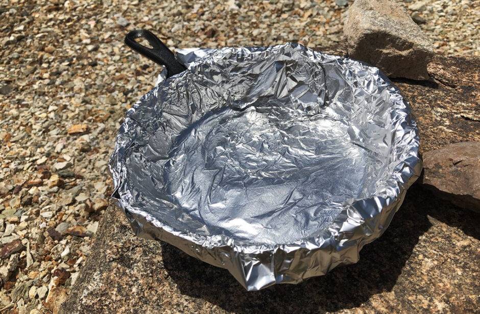 A cast iron pan covered with a layer of tin foil.