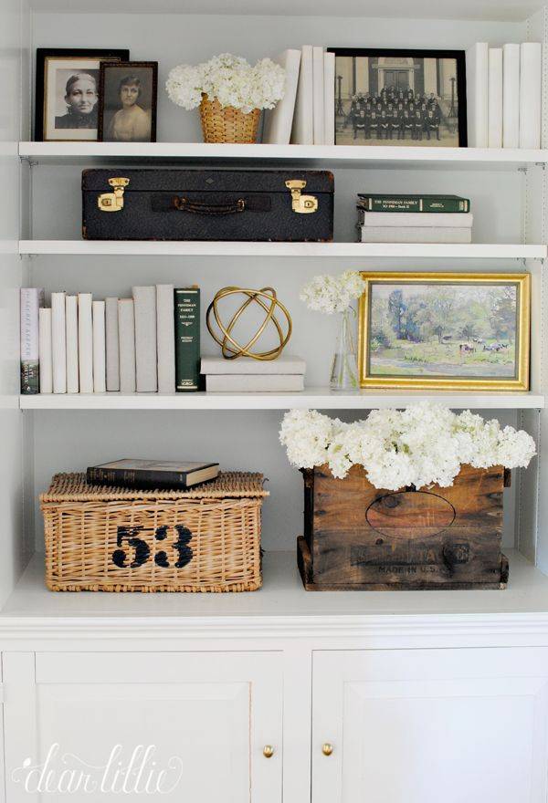 A nicely decorated bookcase with storage.