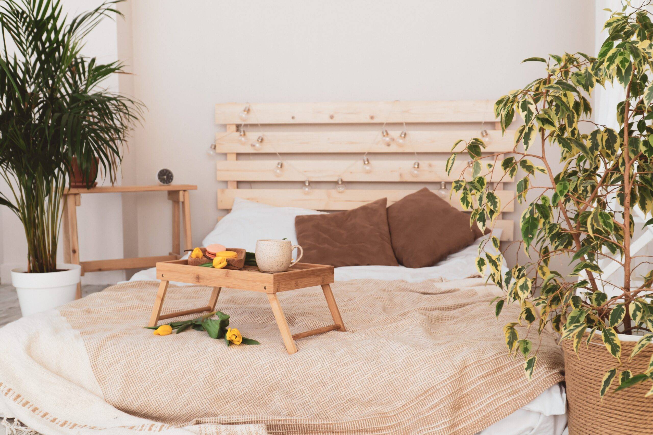 A bed with a light, wooden headboard, one that looks DIY.