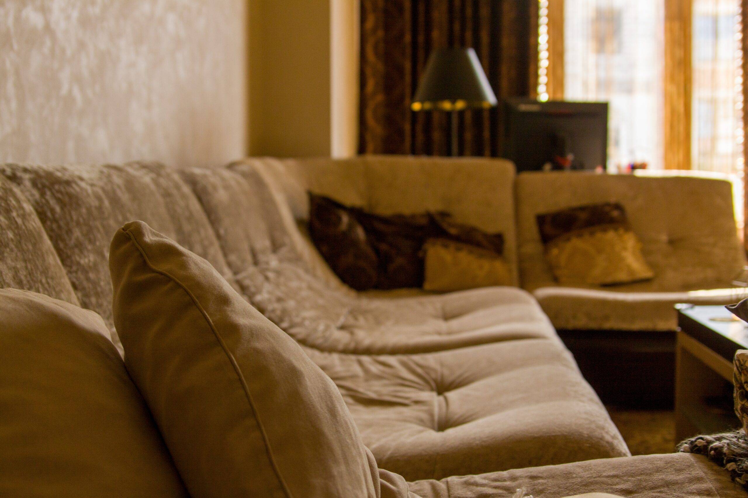 A side view of a light brown L-shaped couch.