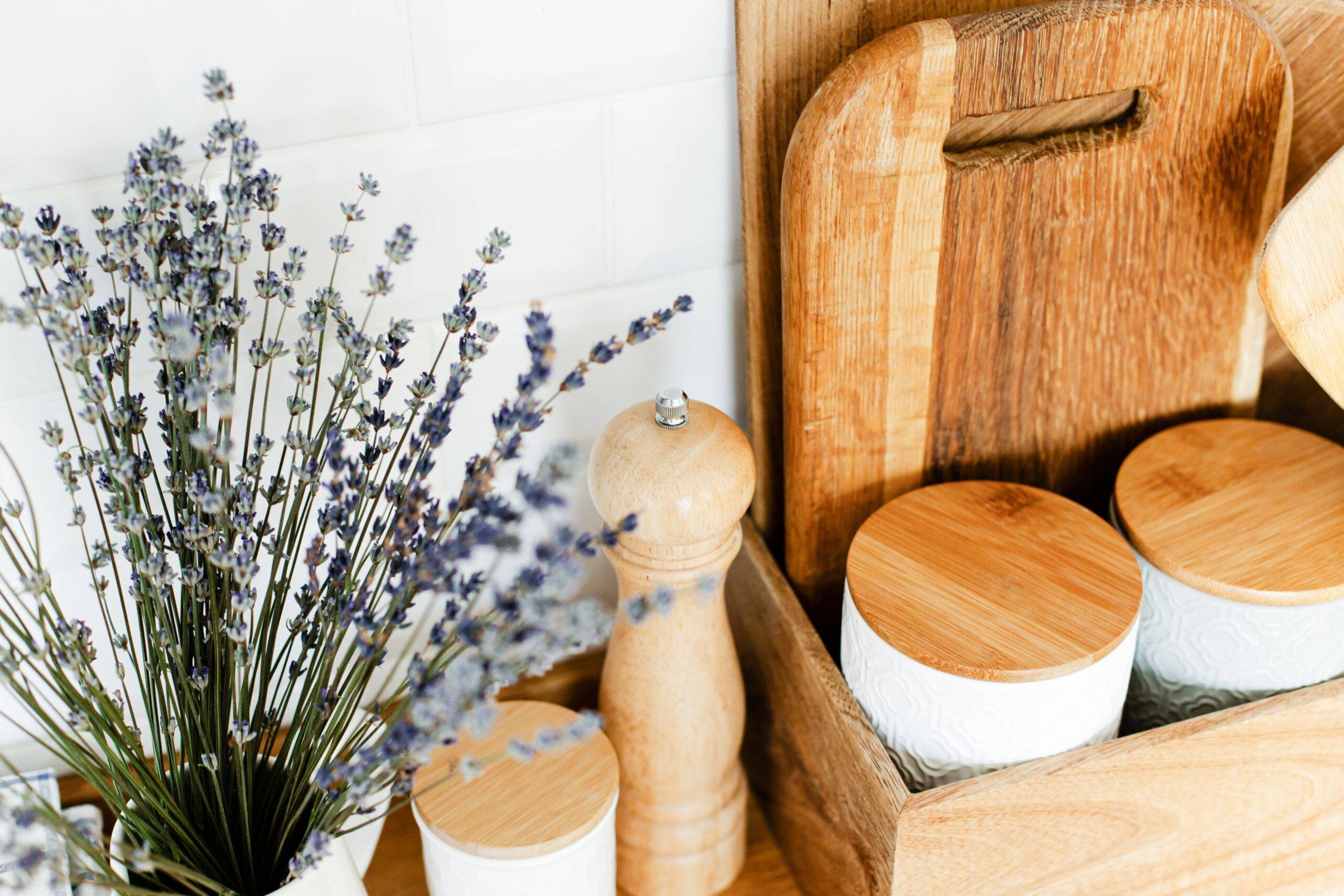 A close photo of some wooden kitchen accessories and a bundle of dried lavender.