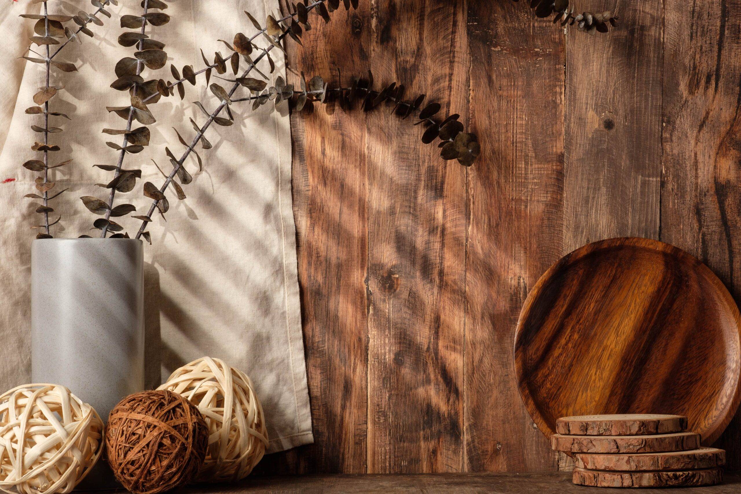 A wood-paneled wall with some natural wood and wicker decor in front of it.