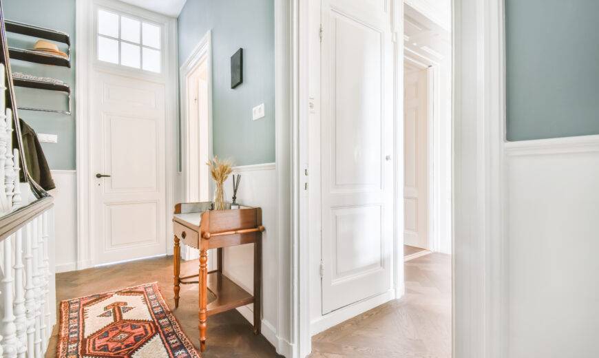 Light blue corridor with a wooden chest of drawers on high legs