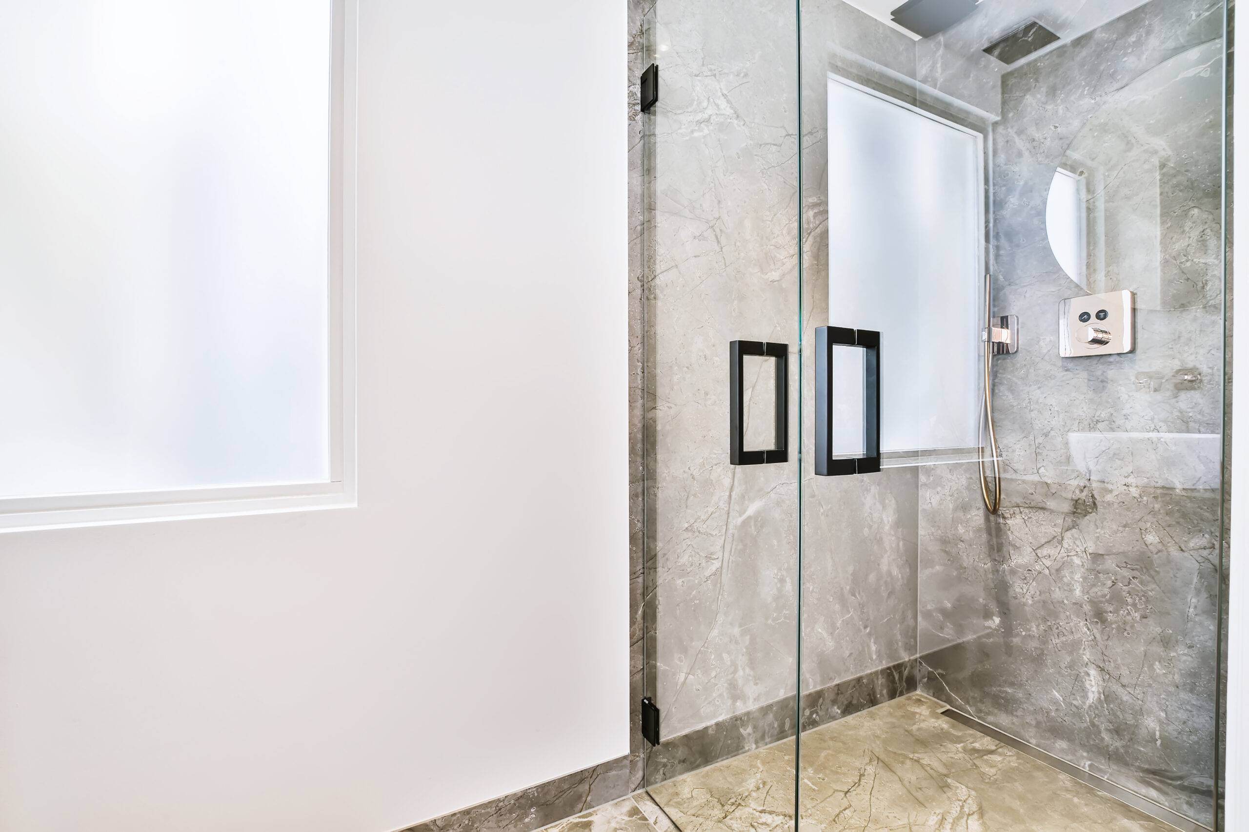 Modern shower stall in a bright bathroom