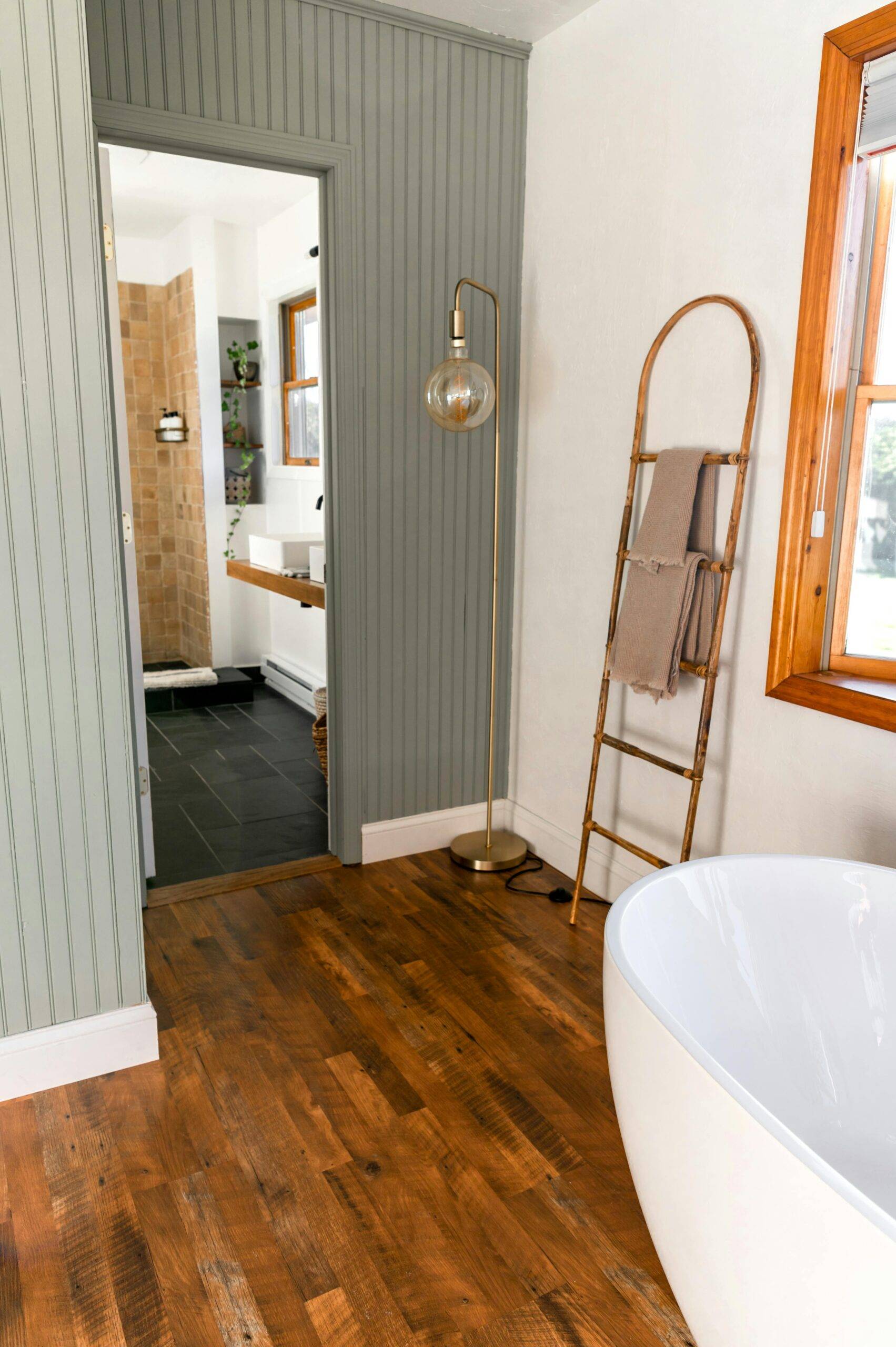 A bathroom, a towel ladder standing up against the wall.