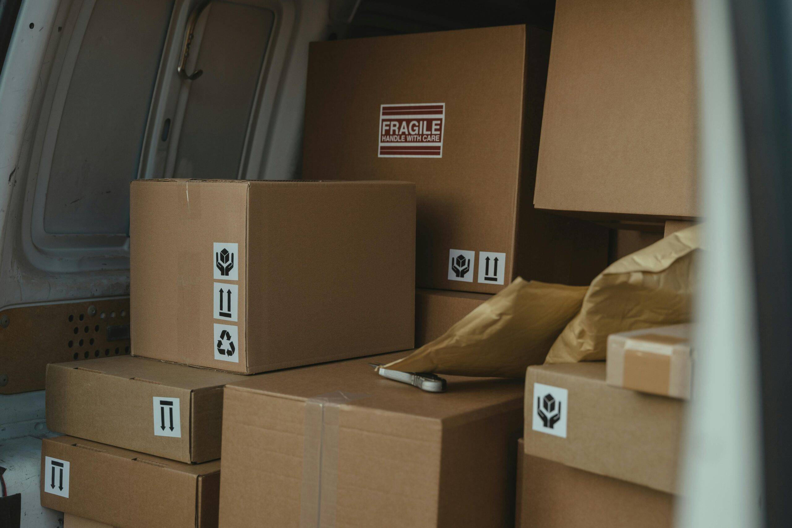 The back of a van full of moving boxes.