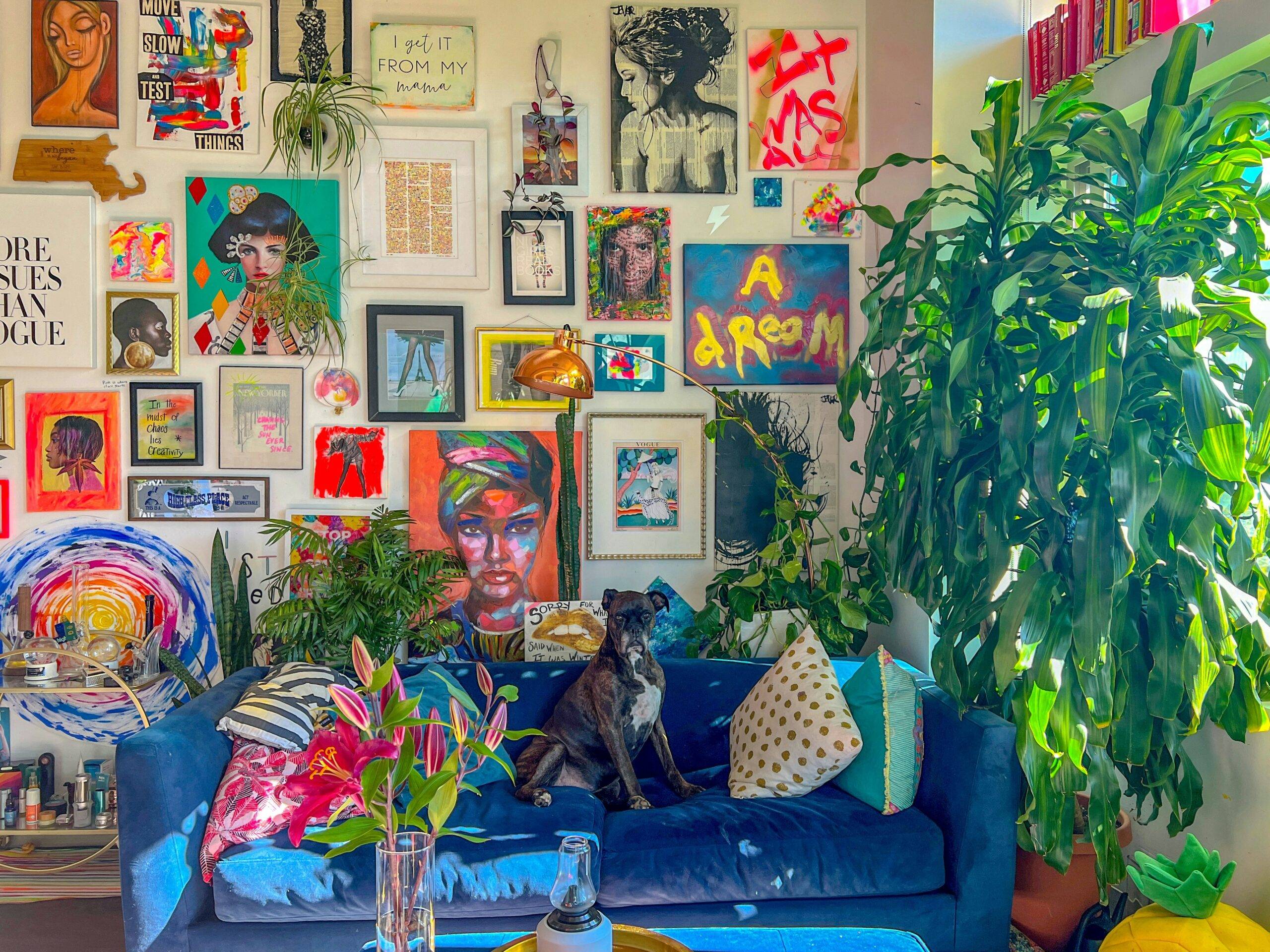 A very colorful room with a wall that's packed full of art.