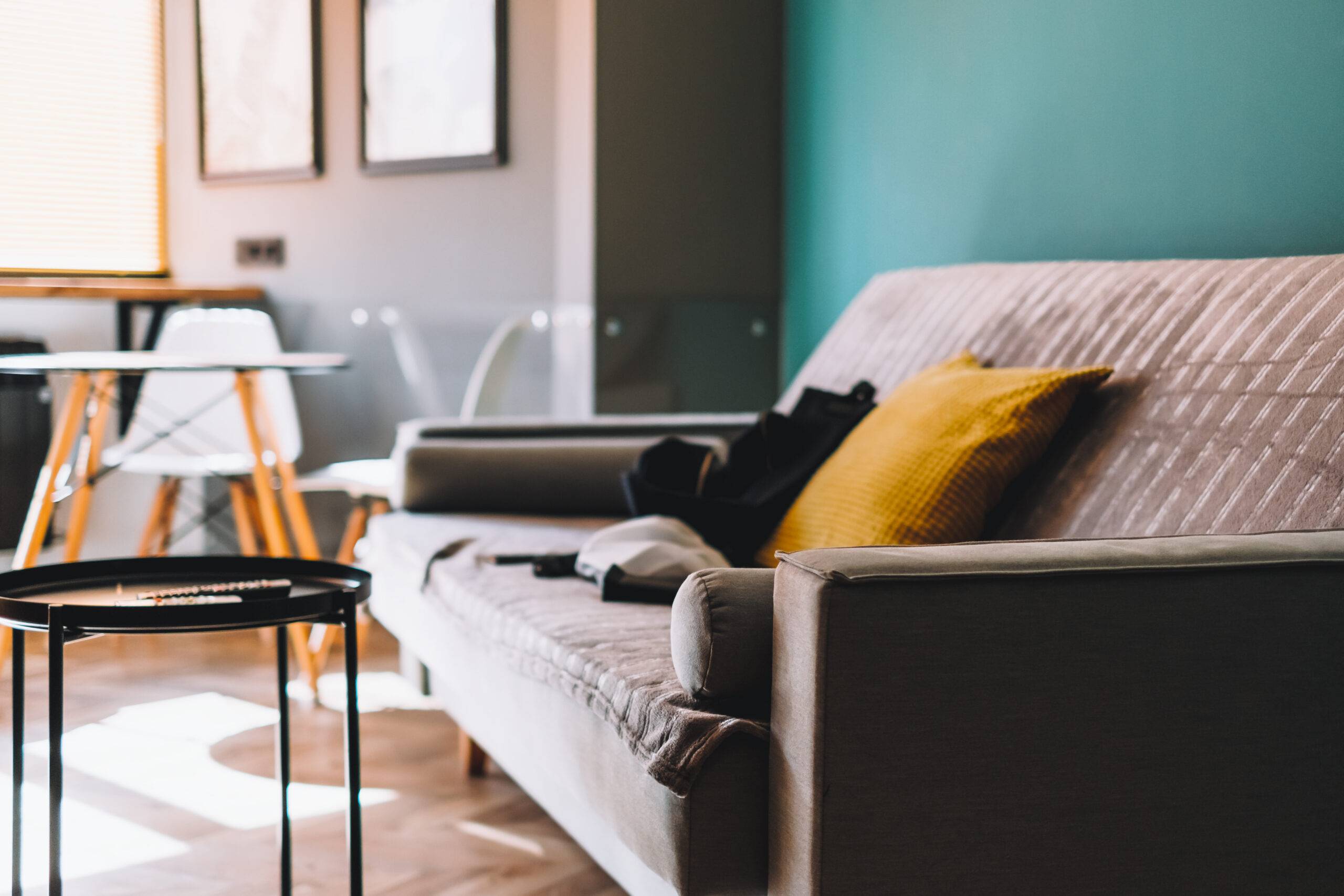 Stylish living room interior of modern apartment with grey sofa and coffee table.