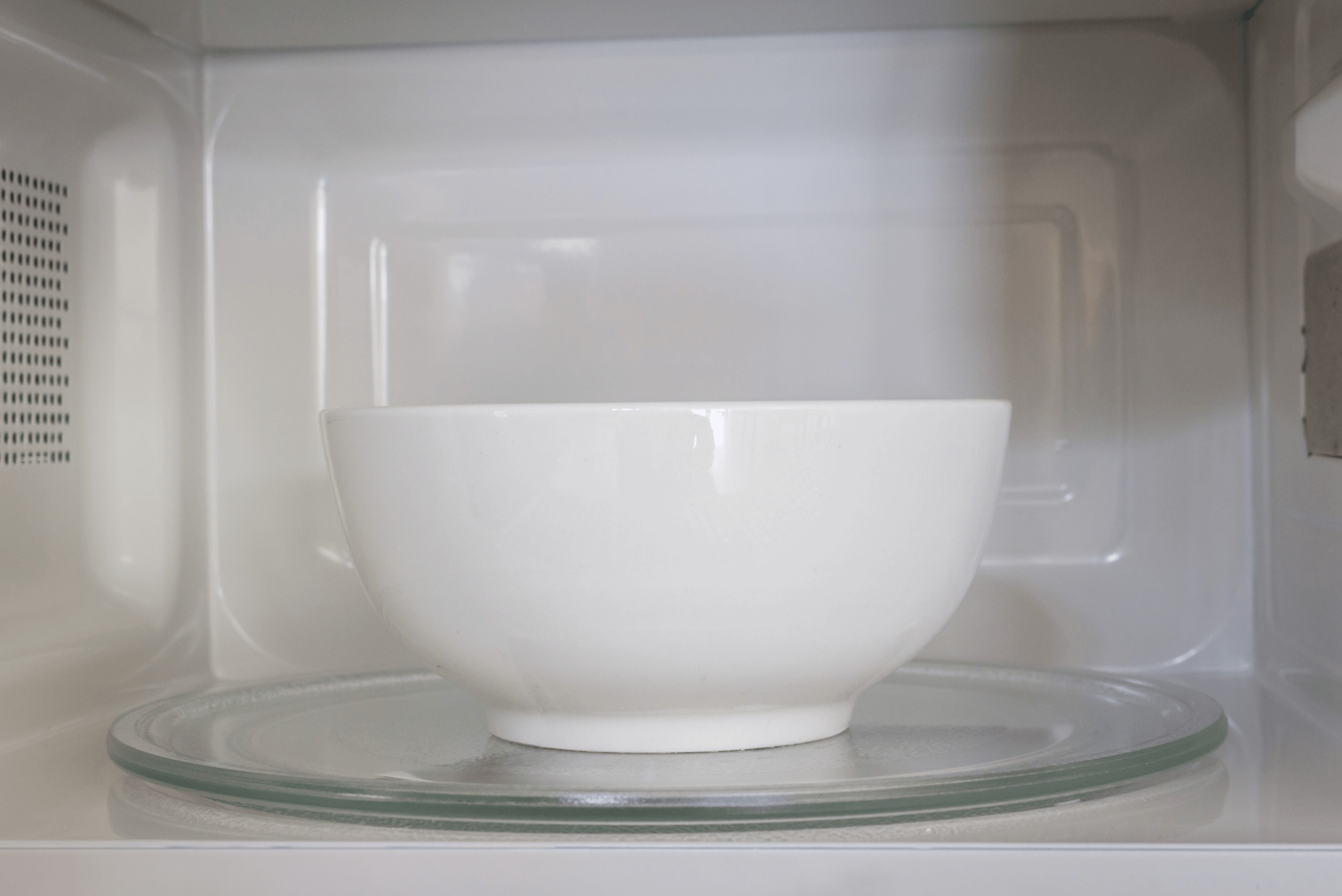 A white bowl in a microwave.