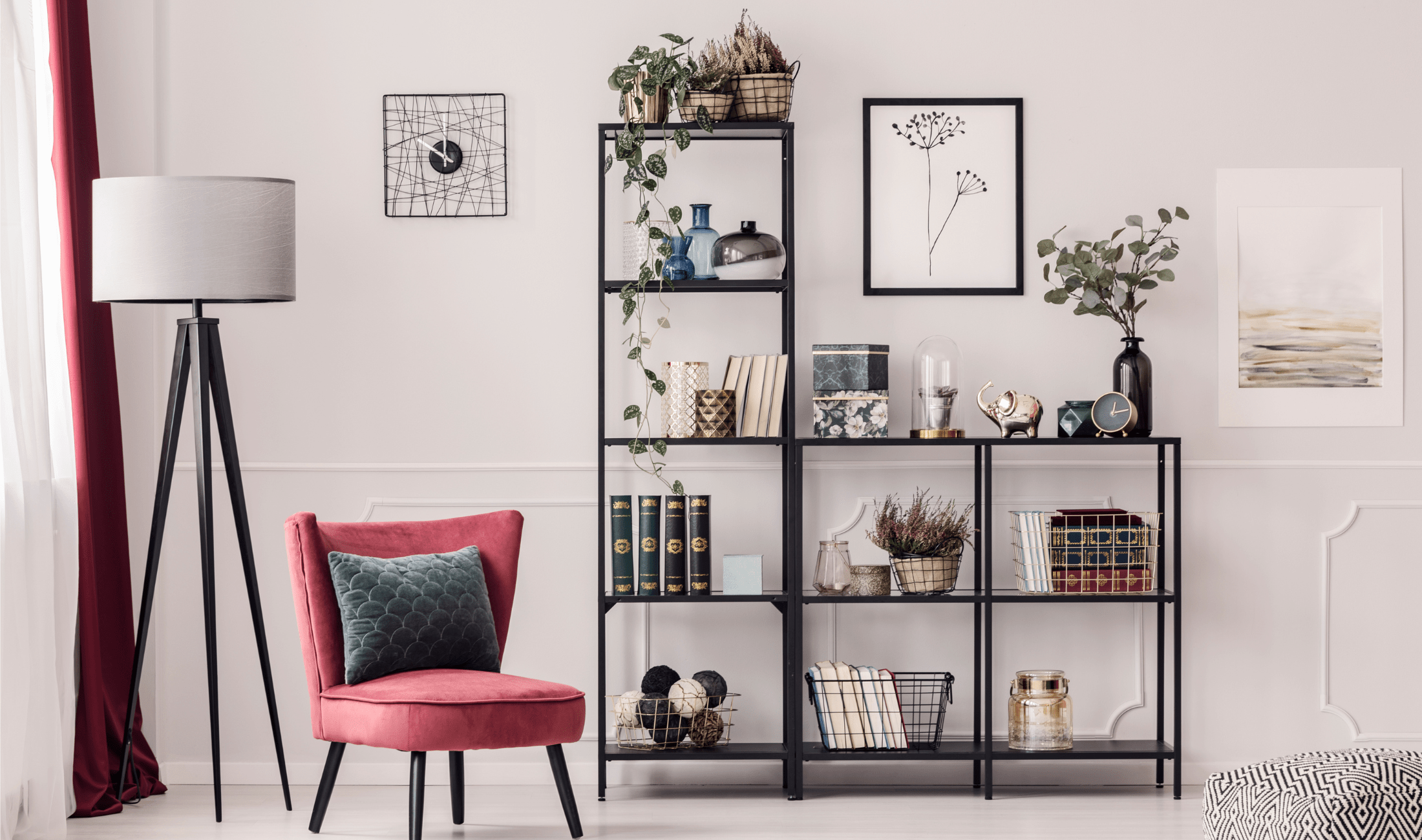 A light, modern bookshelf in a home, hosting books, baskets, and other items. 