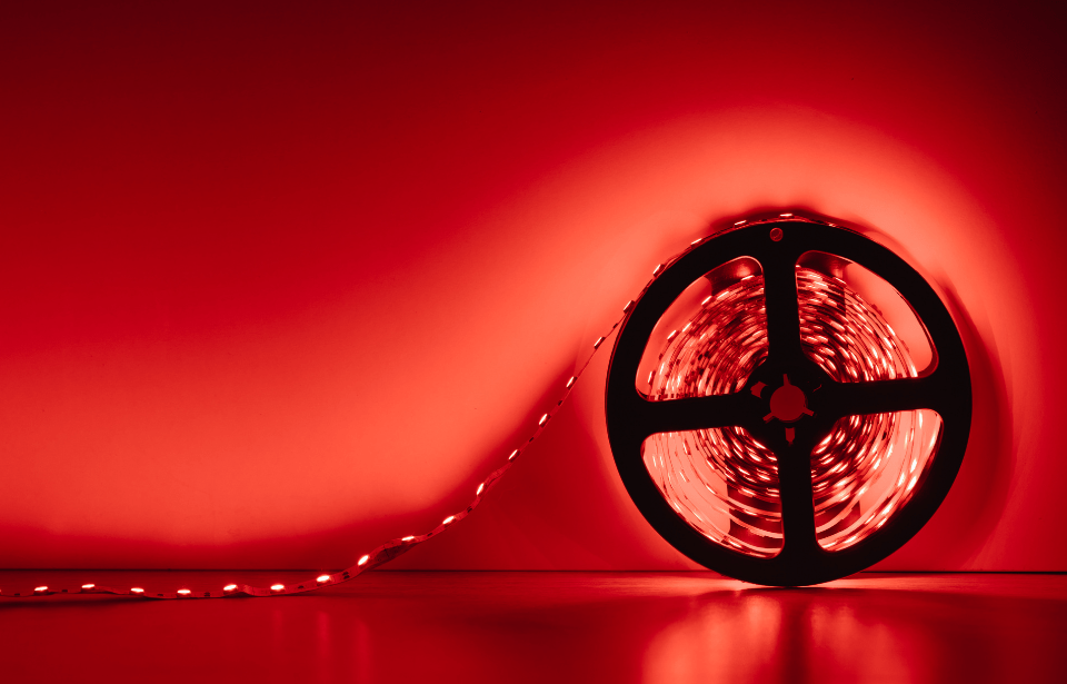 A roll of lit, red LED strip lights.