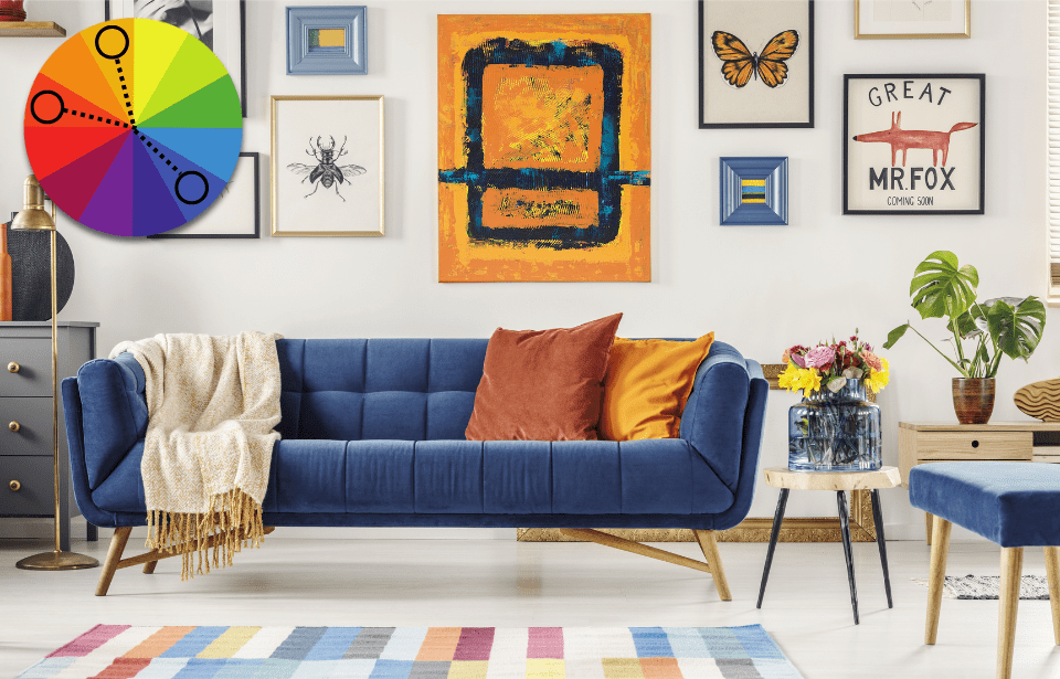 A living room done up in blue and shades of orange. In the top left, there's a color wheel graphic showing a split-complementary color palette color palette.