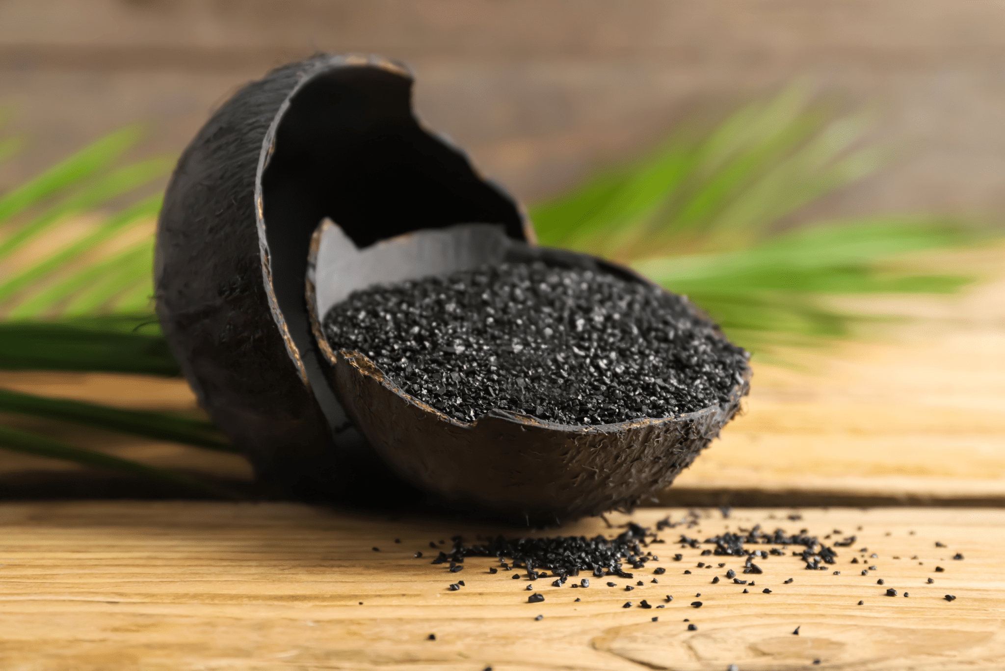 A wooden bowl full of activated charcoal.