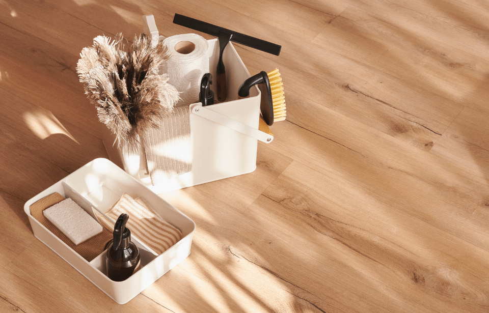 Cleaning supplies in dedicated baskets on the floor.