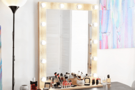 A makeup vanity with lights all around the frame.