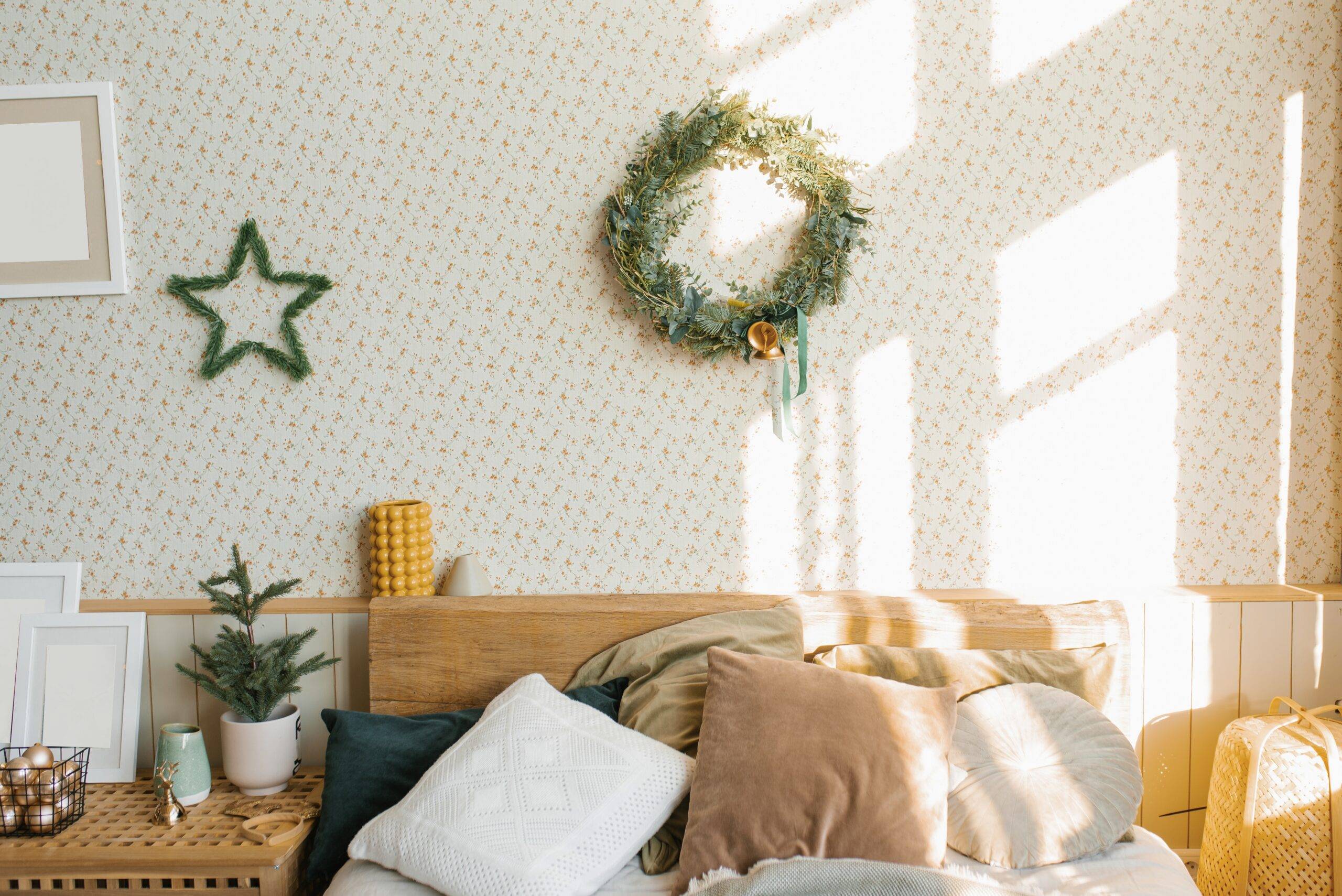 A bed with pillows and Christmas decorations in the bedroom in a Scandinavian style.