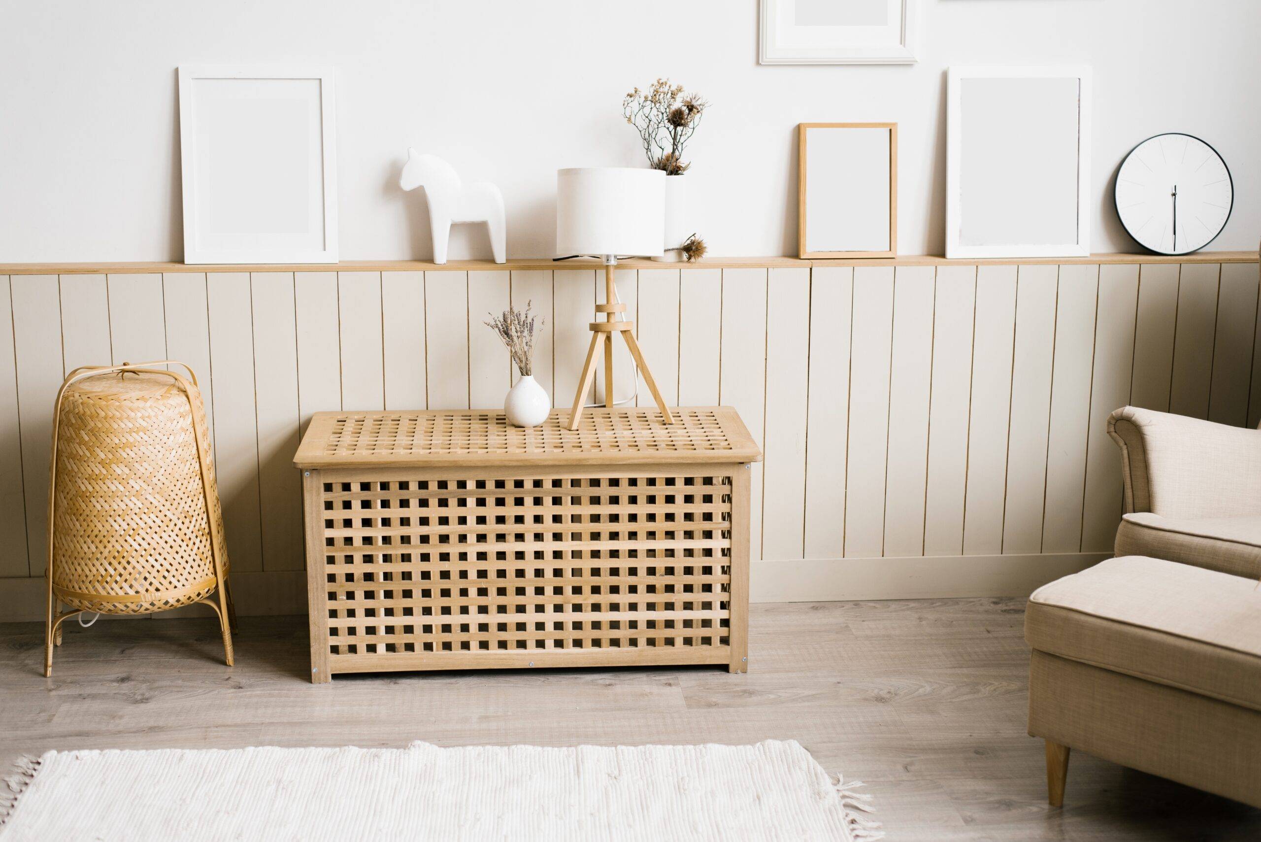 A table lamp, lavender in a white vase in the decor of the living room in a minimalist Scandinavian style. Mockup frames on the wall in a cozy home interior of the living room or bedroom