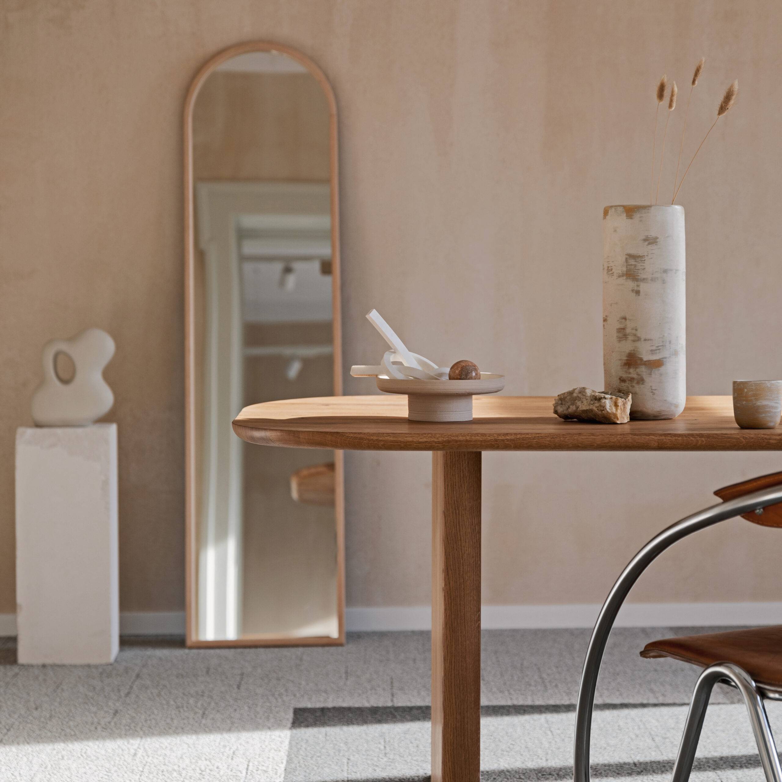 Elegant dining room interior composition with wooden dining table, armchair and design home decorations. Modern home staging. Rustic inspiration. Strucutre wall.