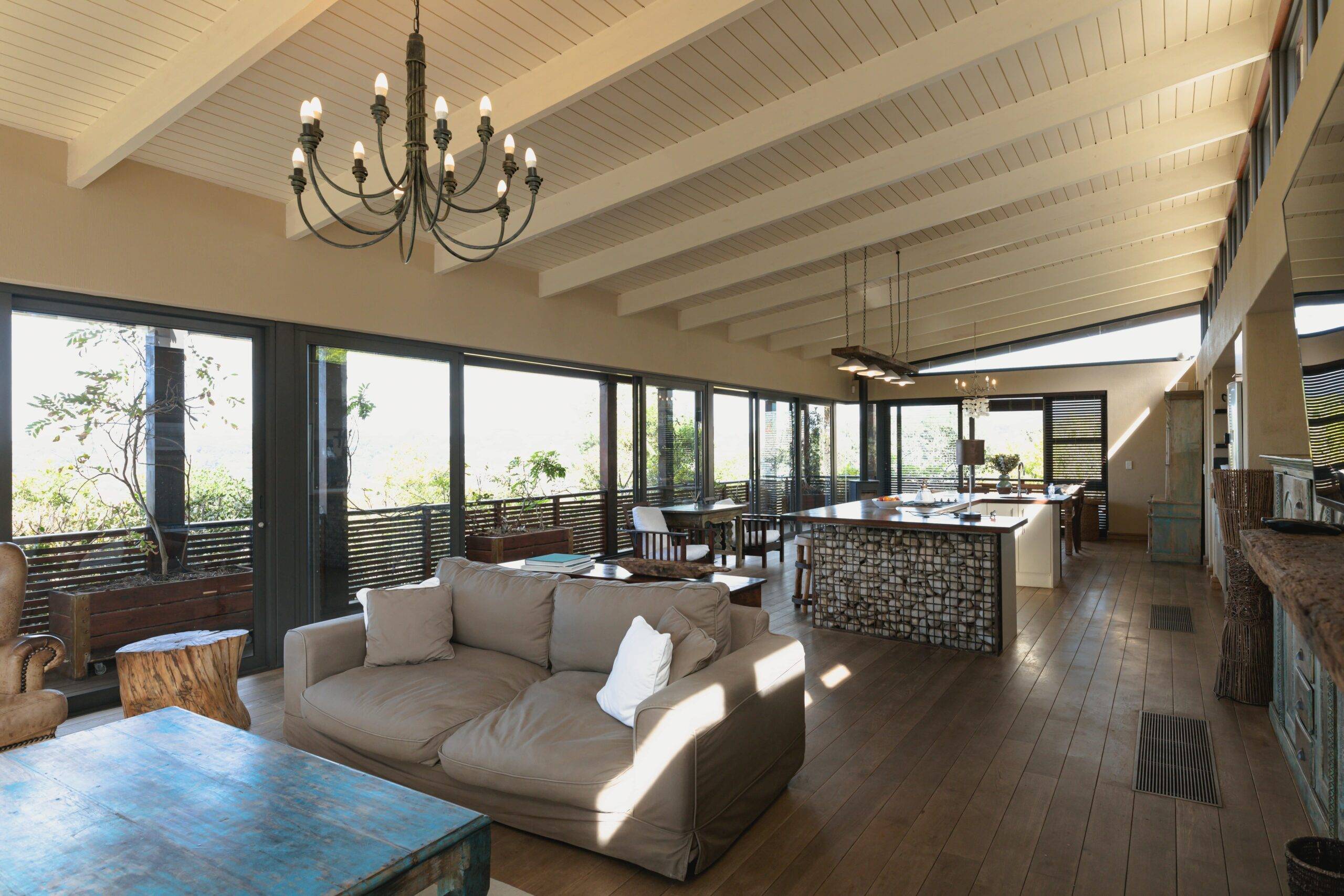 Large open concept room, kitchen behind the living room couch. 