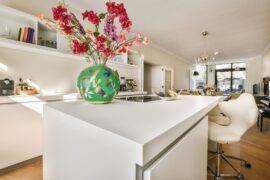 A low shot of a kitchen island with a smooth white countertop.