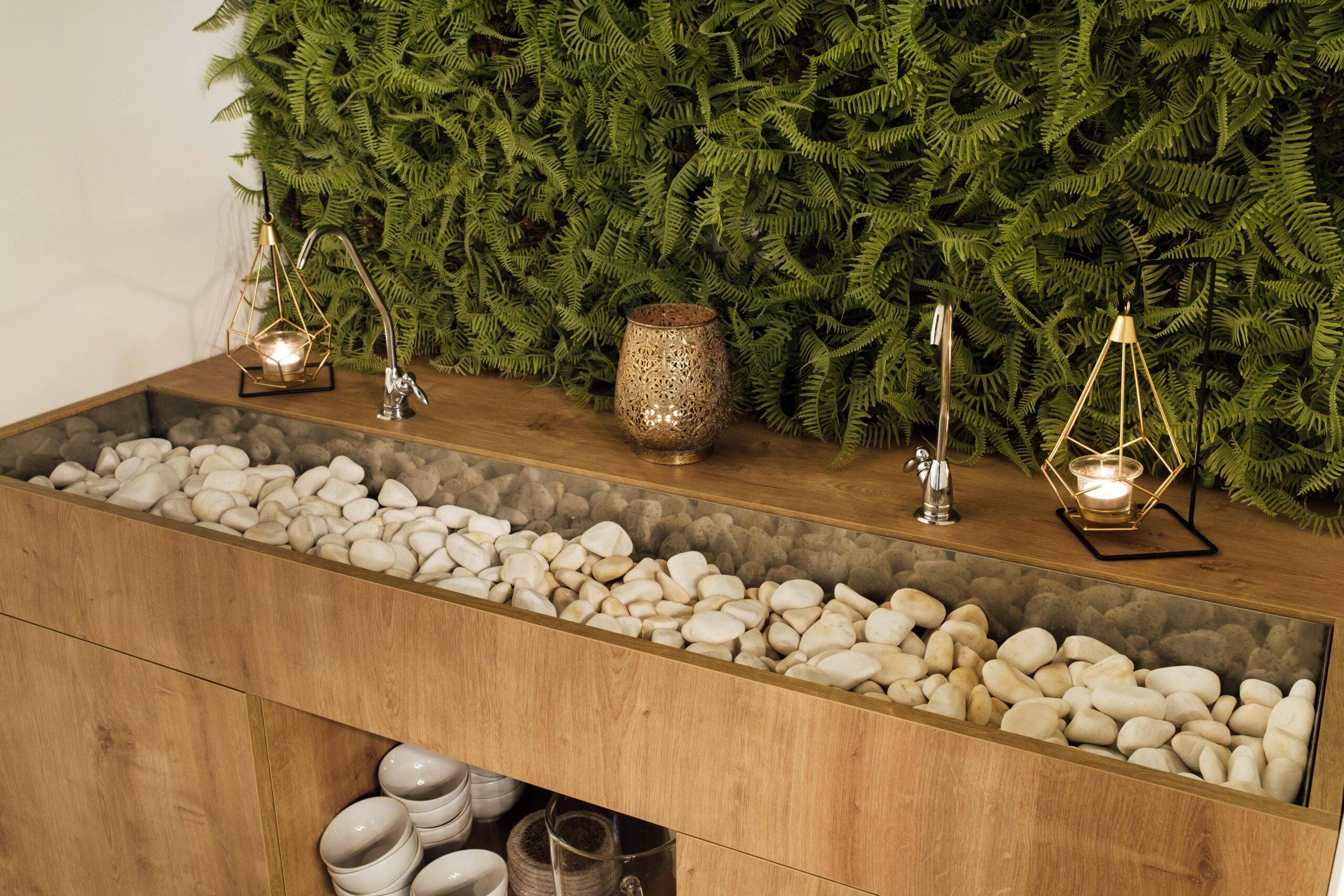 A two person bathroom sink full of stones.