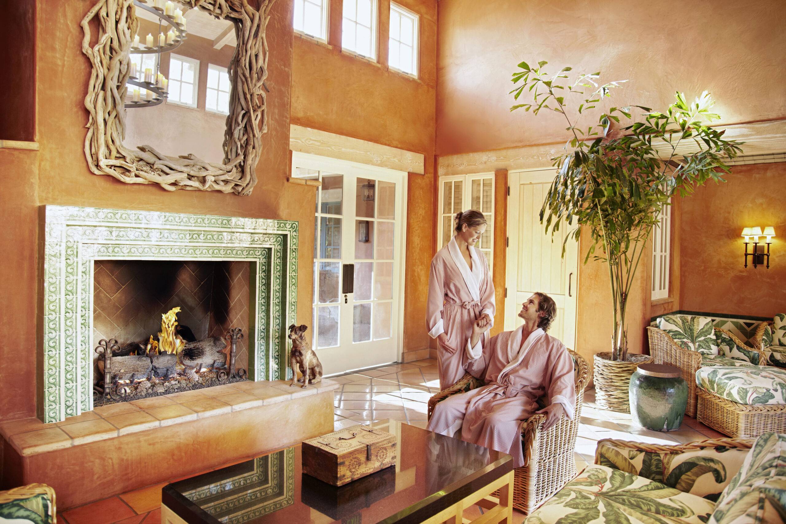 Caucasian couple in robes in resort lounge area